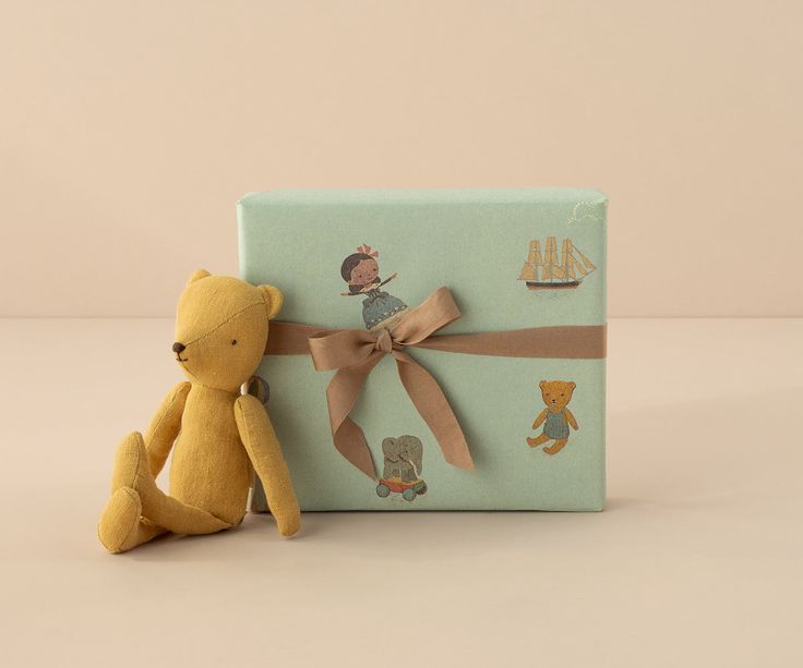 Wrapped Montessori-style gift beside a toddler toy