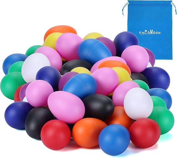 Large pile of colourful COCOMOON plastic egg shakers in ten colours with a drawstring storage bag